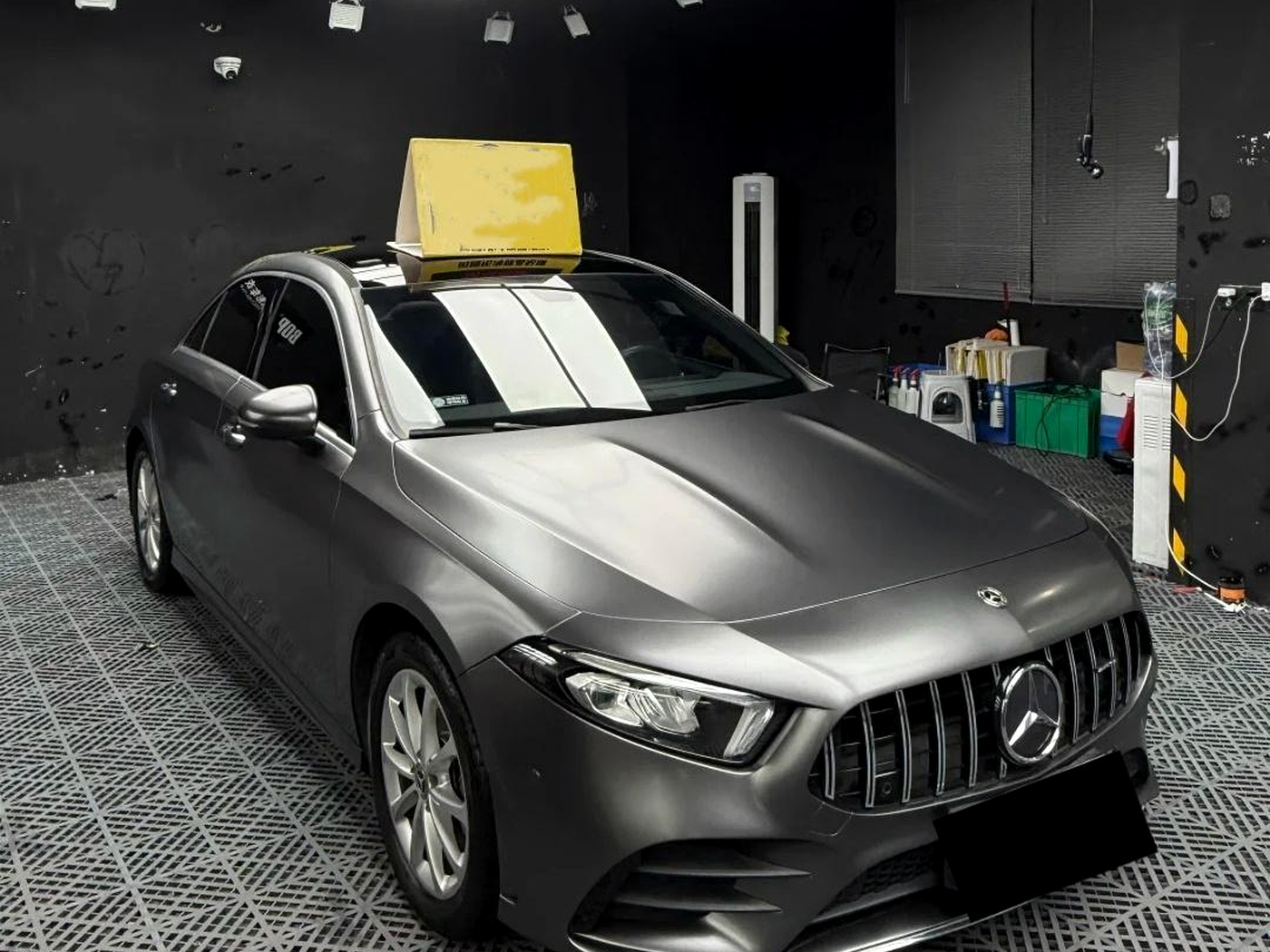 ArmorHue ultra-matte dark grey vehicle wrap in an installation bay